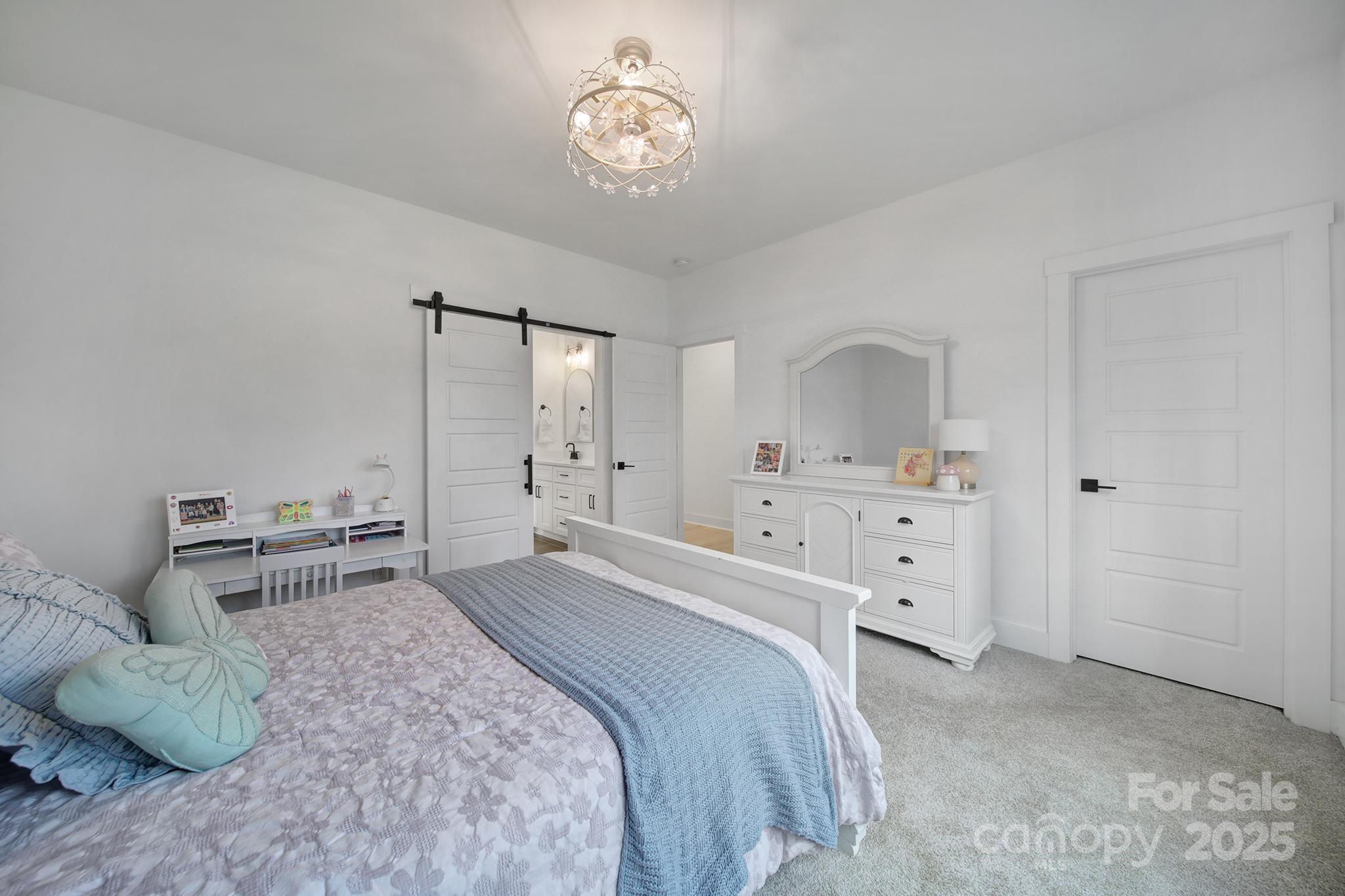 856 Bellegray Road Clover, SC 29710 - Photo 32 of 48 a bedroom with a bed and a chandelier