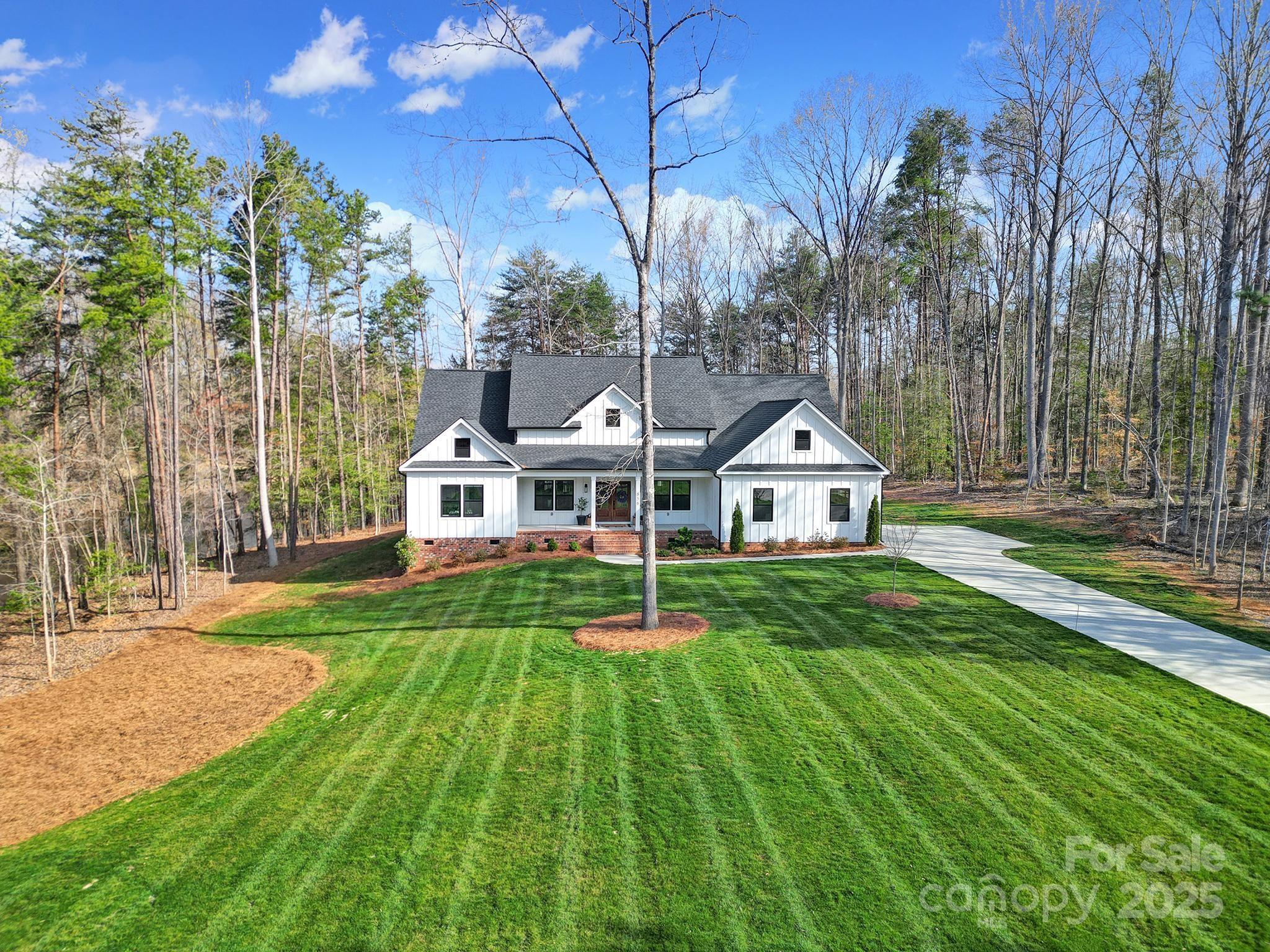 856 Bellegray Road Clover, SC 29710 - Photo 41 of 48 a house with green field in front of it