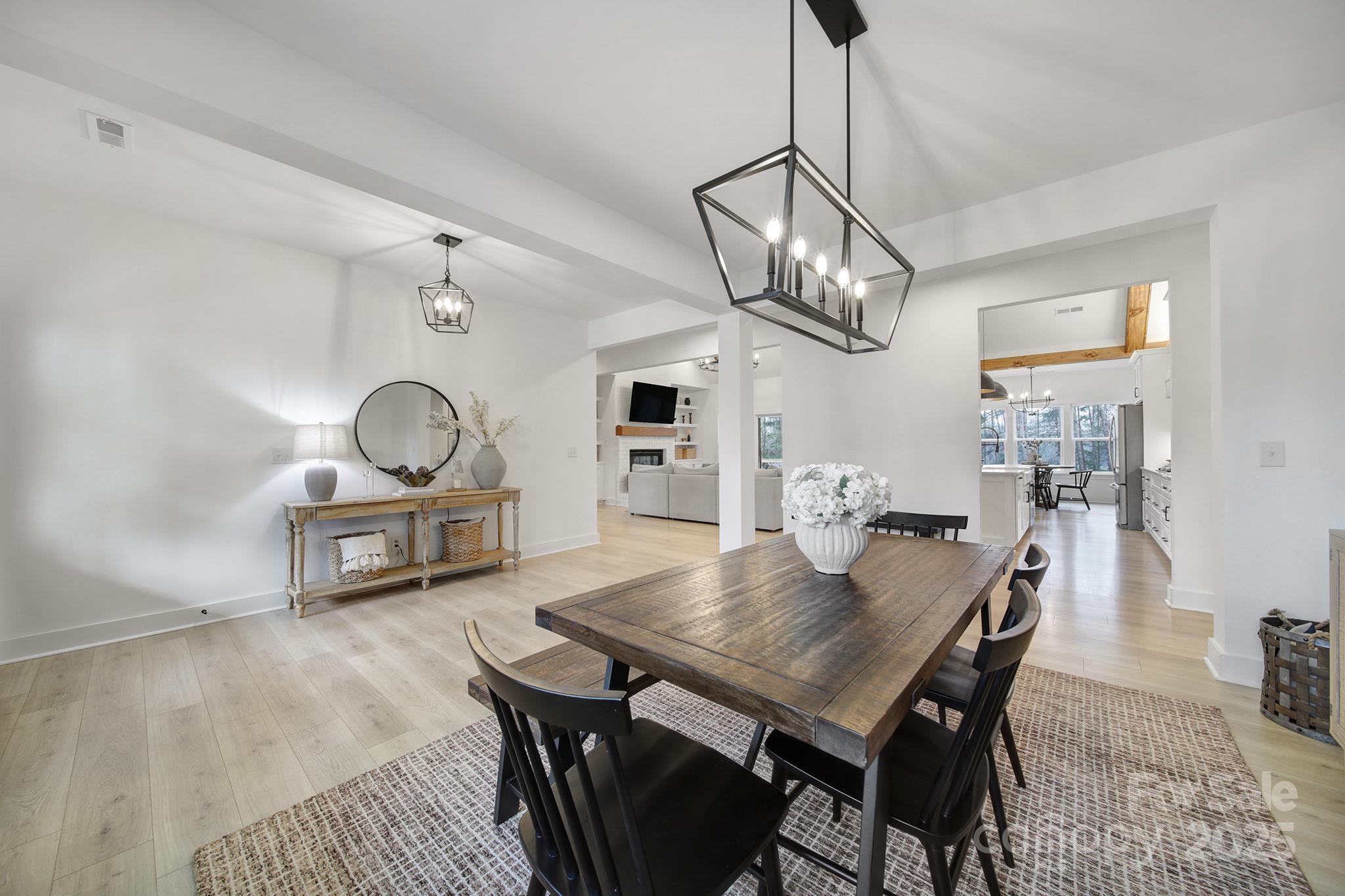 856 Bellegray Road Clover, SC 29710 - Photo 6 of 48 a view of a dining room and livingroom with furniture wooden floor a chandelier