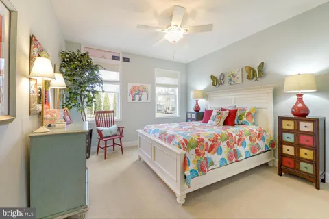 a bedroom with a bed table closet and a window