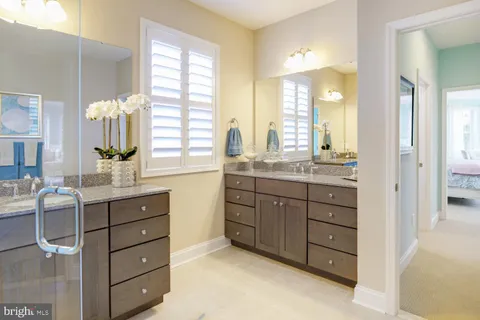 a spacious bathroom with a granite countertop sink mirror and a