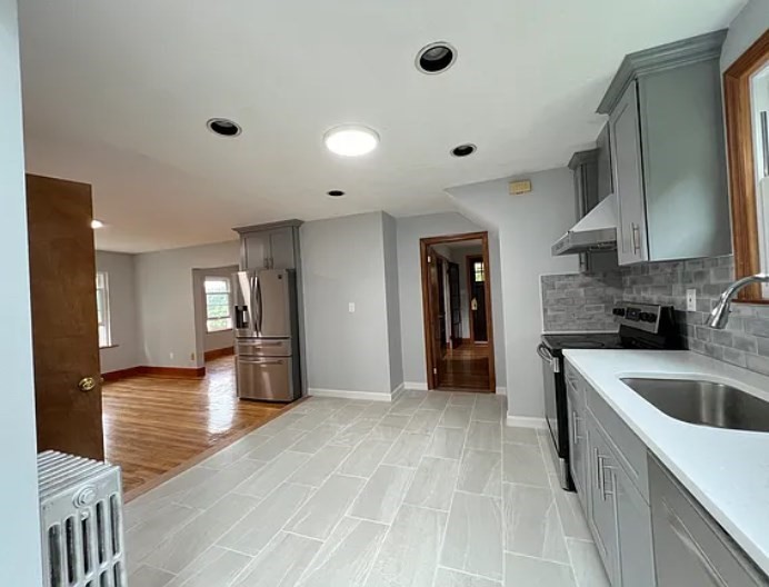 663 Union Street Braintree, MA 02184 - Photo 2 of 9 a kitchen with stainless steel appliances granite countertop a sink and cabinets