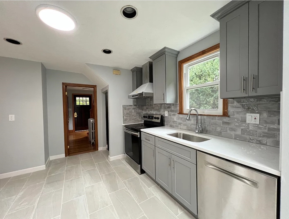 663 Union Street Braintree, MA 02184 - Photo 3 of 9 a kitchen with a sink stove and cabinets