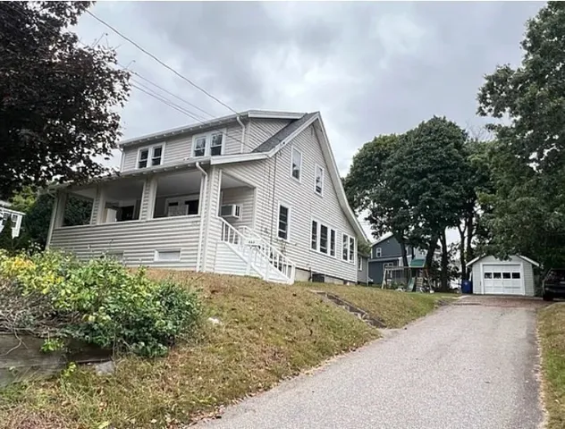 a front view of a house with a yard garage and outdoor seating