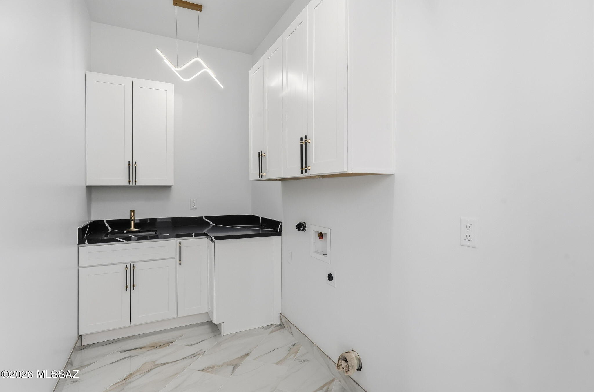 1786 Peralta Court Rio Rico, AZ 85648 - Photo 26 of 50 a view of a kitchen with white cabinets and stainless steel appliances
