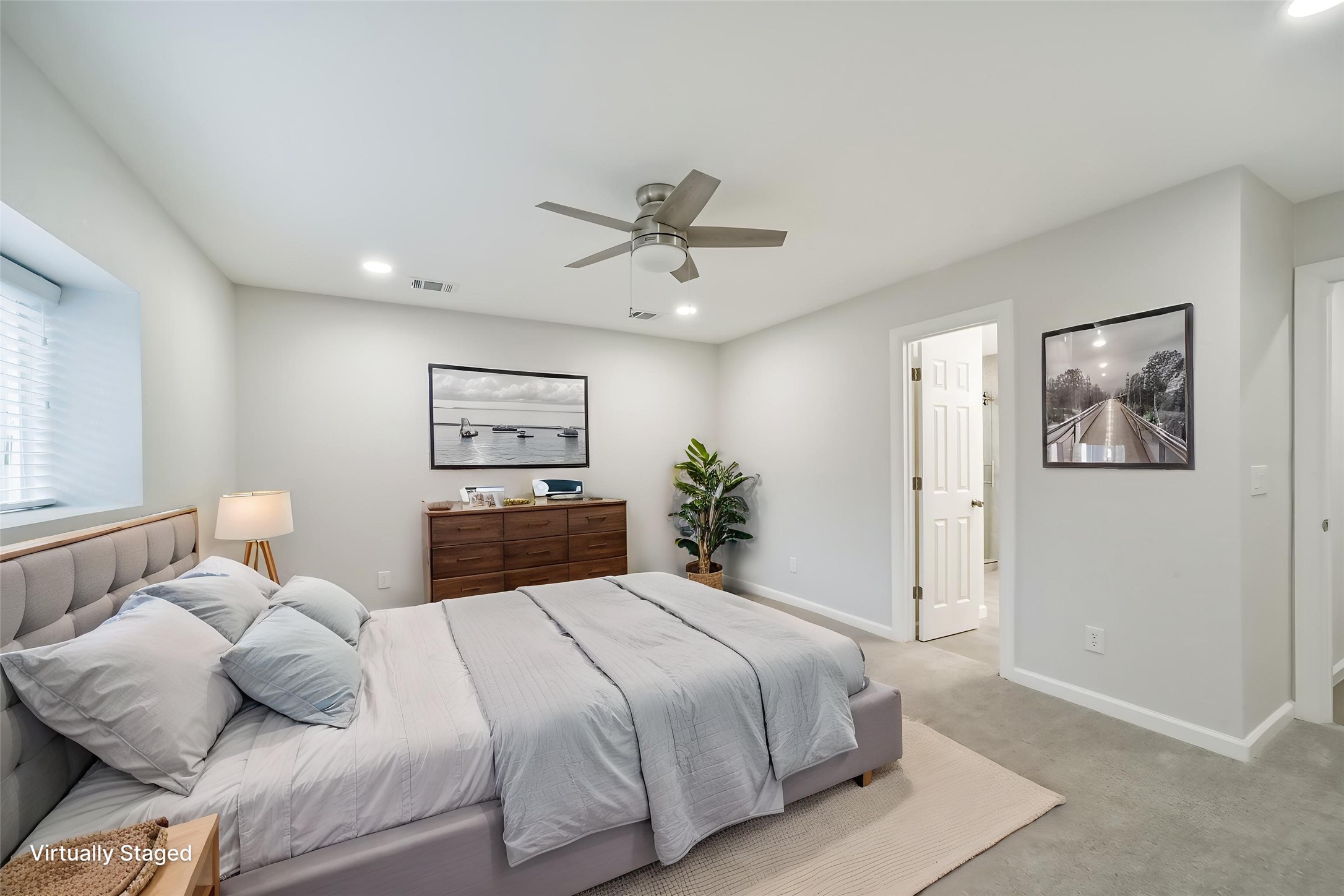15610 Ripplewind Lane Houston, TX 77068 - Photo 4 of 44 a bedroom with a bed and a chandelier