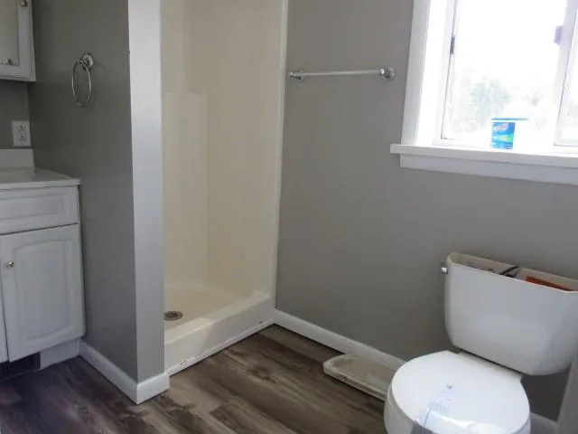 a white toilet sitting next to a bathroom sink