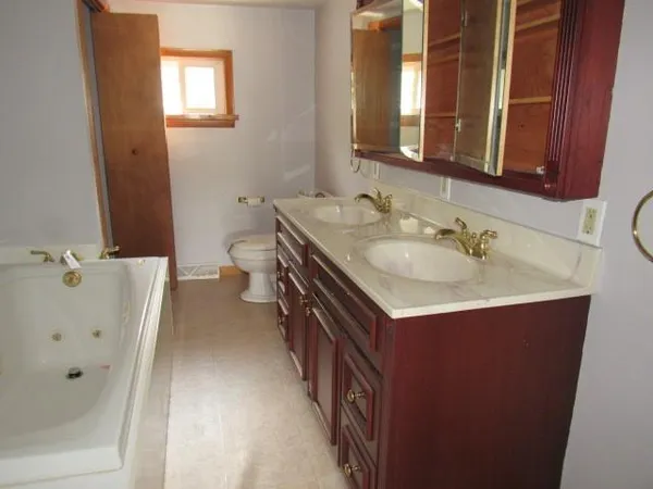 a bathroom with a double vanity sink and mirror