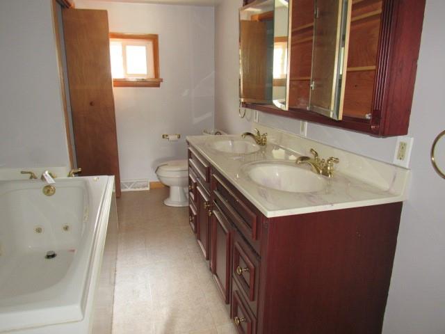 123 2nd Street Normalville, PA 15469 - Photo 18 of 26 a bathroom with a double vanity sink and mirror