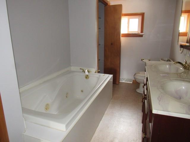 123 2nd Street Normalville, PA 15469 - Photo 19 of 26 a bathroom with a tub sink and window