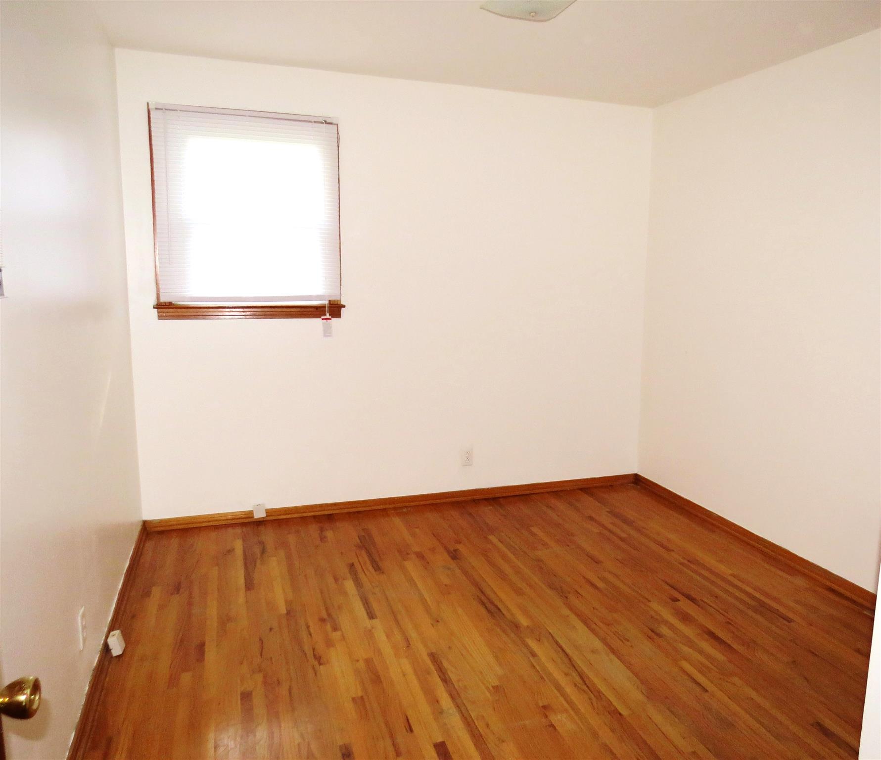 734 Moormans Arm Road Nashville, TN 37207 - Photo 8 of 13 a view of an empty room with wooden floor and a window