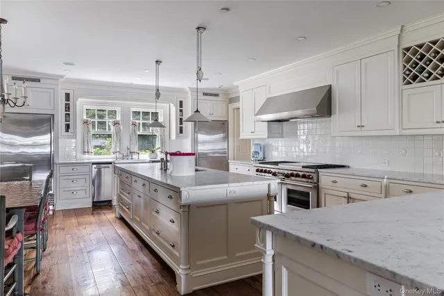 a spacious bathroom with a double vanity sink a mirror a bathtub and