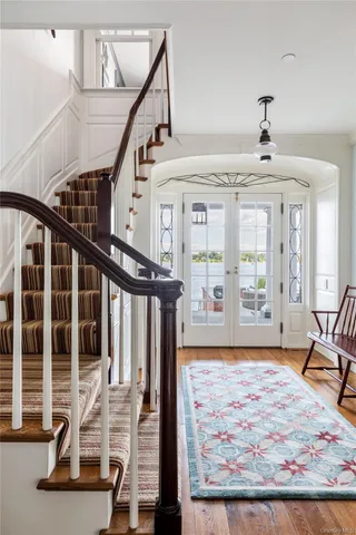 a living room with furniture a fireplace and a chandelier