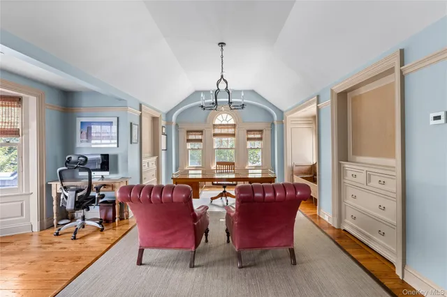 a view of a hallway with a livingroom with furniture