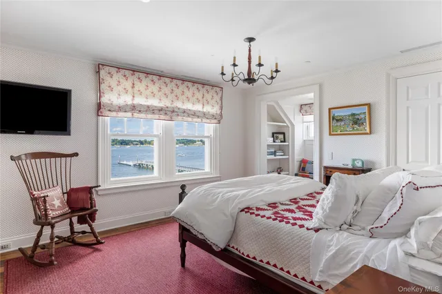 a bedroom with a large bed and a large window