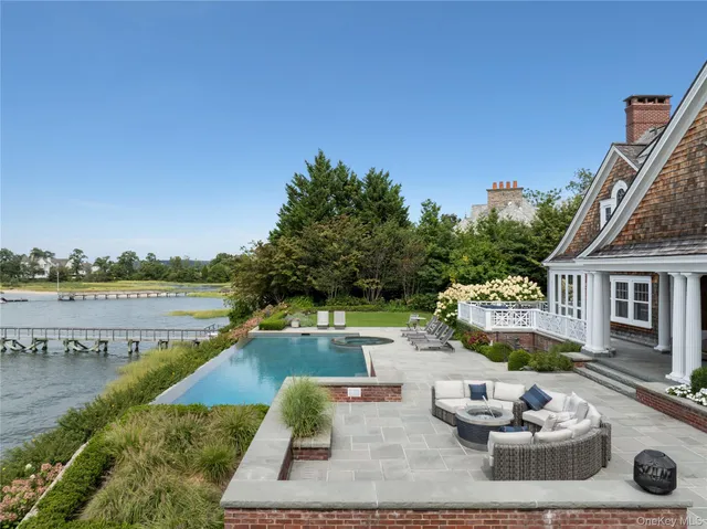 a view of a house with backyard and lake view