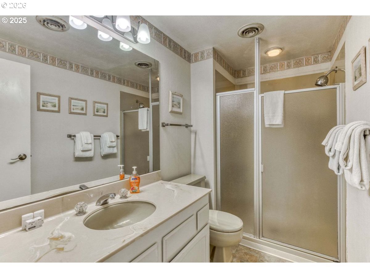 475 South Promenade, Unit 518 Seaside, OR 97138 - Photo 22 of 29 a bathroom with a granite countertop sink toilet and shower
