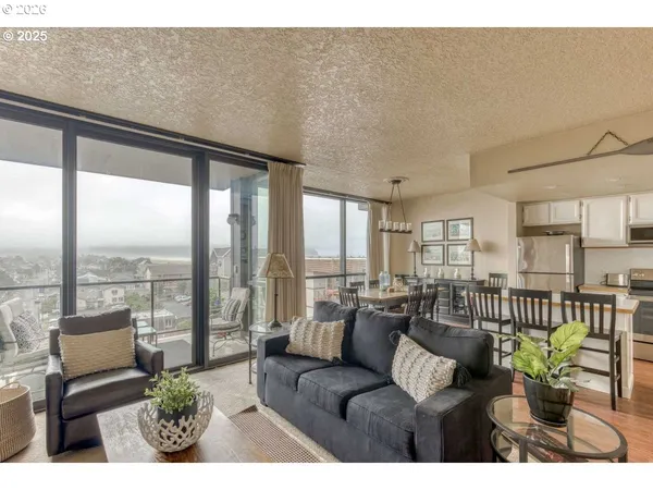 a living room with furniture and floor to ceiling windows