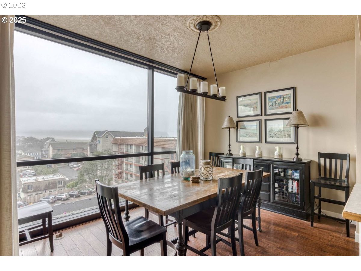 475 South Promenade, Unit 518 Seaside, OR 97138 - Photo 7 of 29 a view of a dining room with furniture window and wooden floor