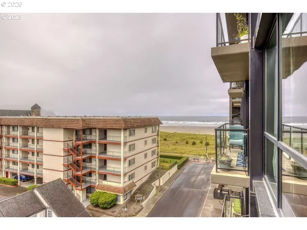 a view of a balcony with floor to ceiling windows and wooden floor