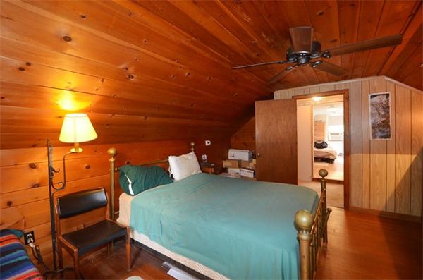 63 Concord Road Wayland, MA 01778 - Photo 20 of 30 a bedroom with a bed and wooden floor