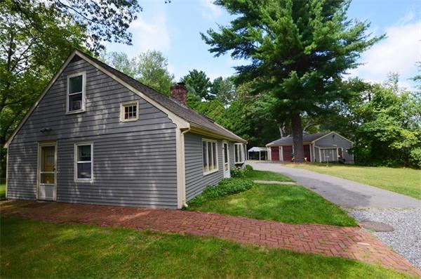 63 Concord Road Wayland, MA 01778 - Photo 26 of 30 a front view of a house with a garden