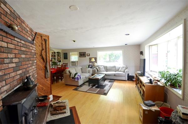 63 Concord Road Wayland, MA 01778 - Photo 7 of 30 a living room with furniture a window and gym equipment