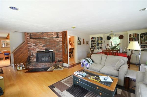 63 Concord Road Wayland, MA 01778 - Photo 8 of 30 a living room with furniture and a fireplace