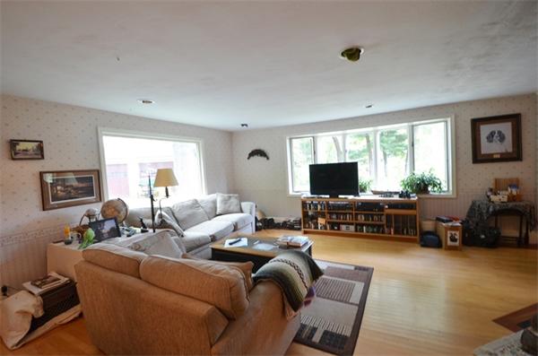 63 Concord Road Wayland, MA 01778 - Photo 10 of 30 a living room with furniture and a flat screen tv