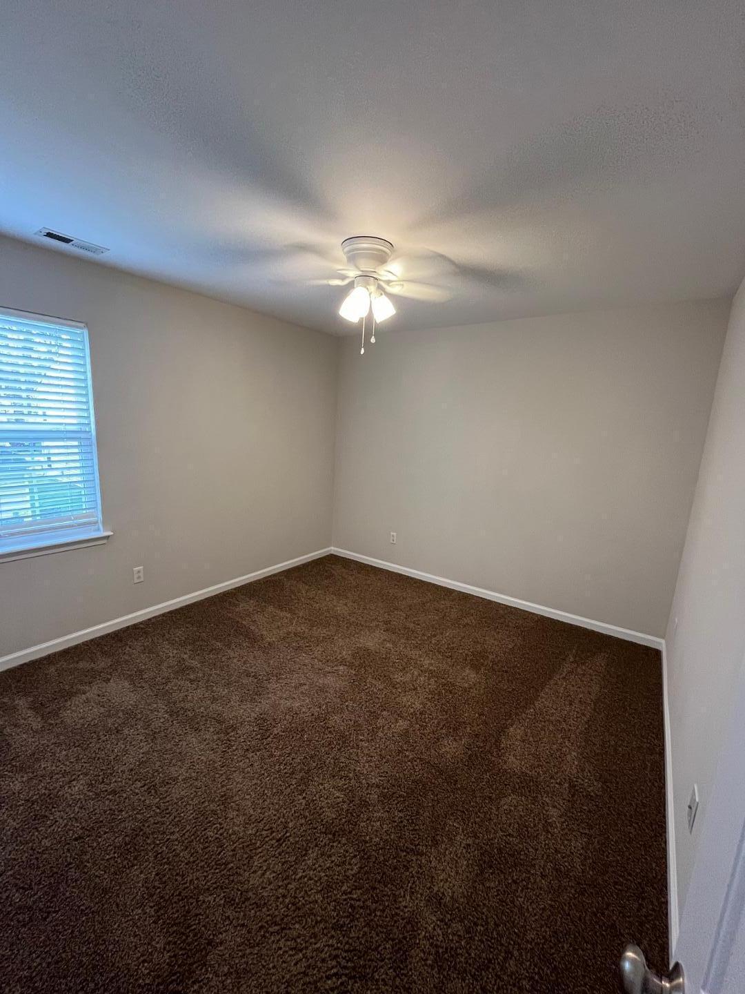 5104 Thornton Knoll Way Raleigh, NC 27616 - Photo 12 of 21 an empty room with a fan & a window