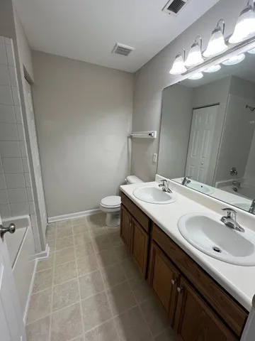 a bathroom with a sink double vanity and a mirror