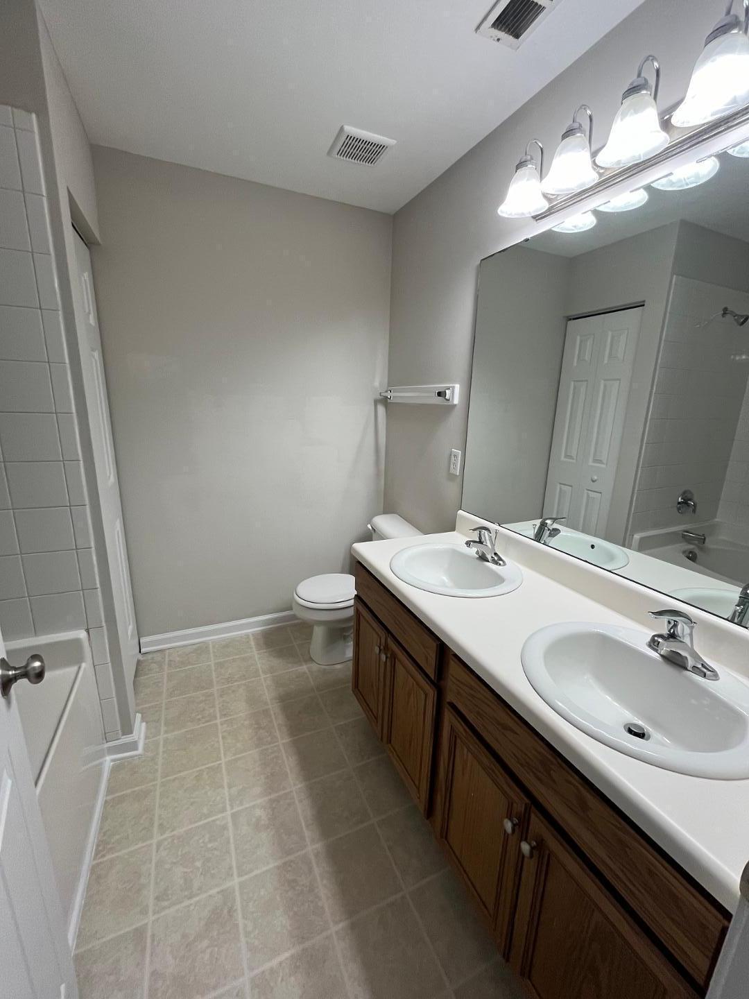 5104 Thornton Knoll Way Raleigh, NC 27616 - Photo 14 of 21 a bathroom with a sink double vanity and a mirror