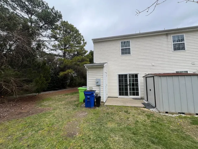 a backyard of a house with table and chairs