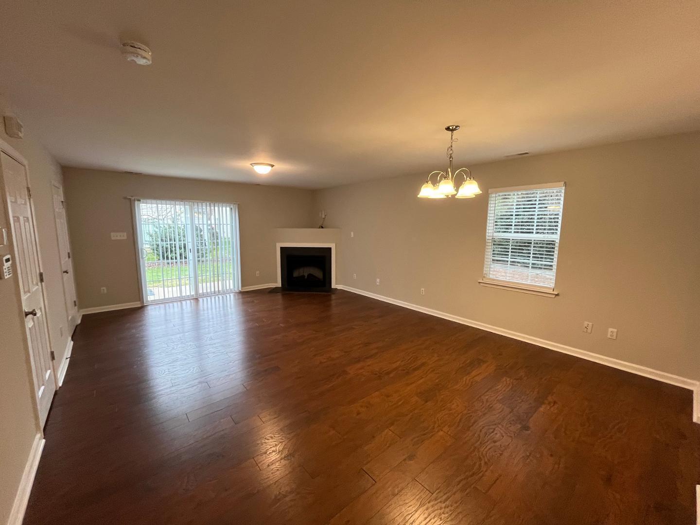 5104 Thornton Knoll Way Raleigh, NC 27616 - Photo 4 of 21 an empty room with wooden floor and windows