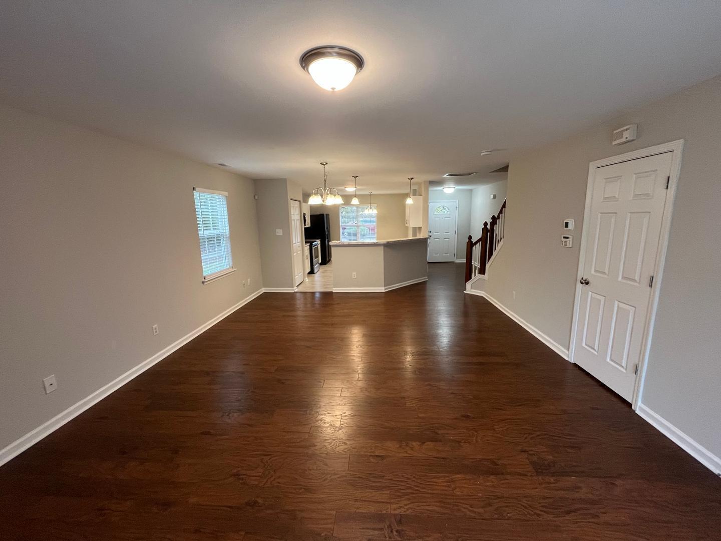 5104 Thornton Knoll Way Raleigh, NC 27616 - Photo 5 of 21 an empty room with wooden floor and windows