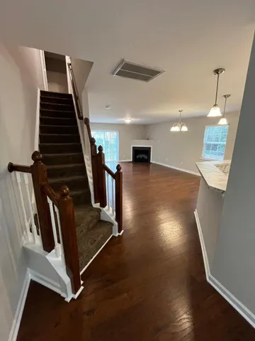 a view of an entryway with wooden floor