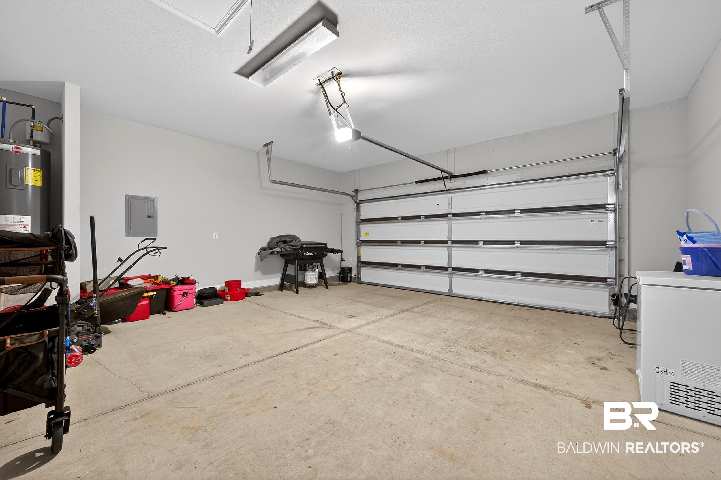 1084 Stella Road Foley, AL 36535 - Photo 29 of 31 Garage with electric panel, electric water heater, and white fridge