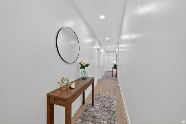 1165 West Union Bench Drive Mapleton, UT 84664 - Photo 46 of 61 Hallway featuring wood-finish flooring, recessed lighting, and white paneled doors