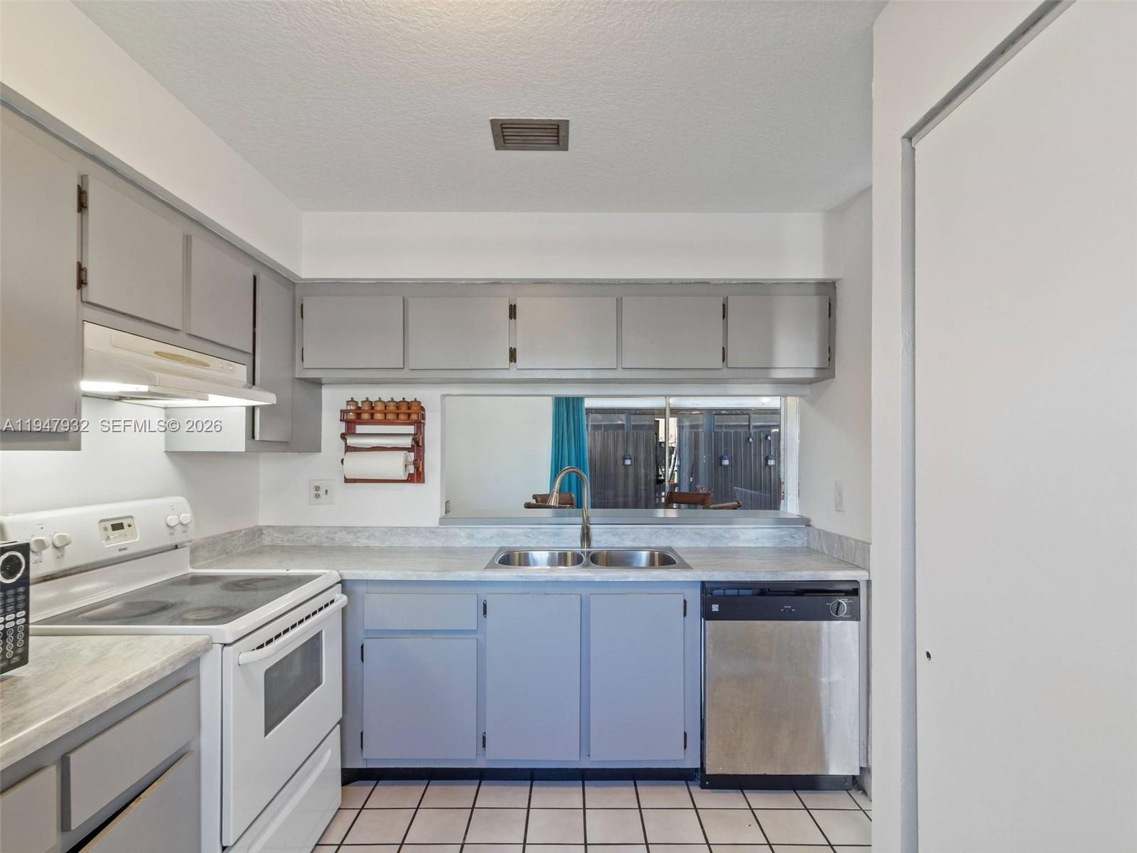 9066 Southwest 147th Court Miami, FL 33196 - Photo 12 of 31 a kitchen with stainless steel appliances granite countertop a sink stove and cabinets