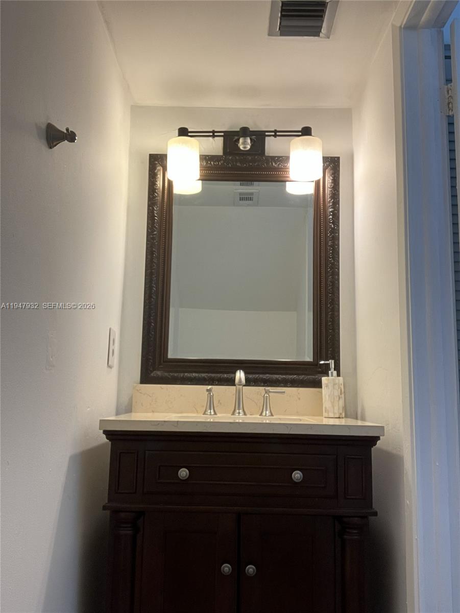 9066 Southwest 147th Court Miami, FL 33196 - Photo 13 of 31 a bathroom with a sink and a mirror
