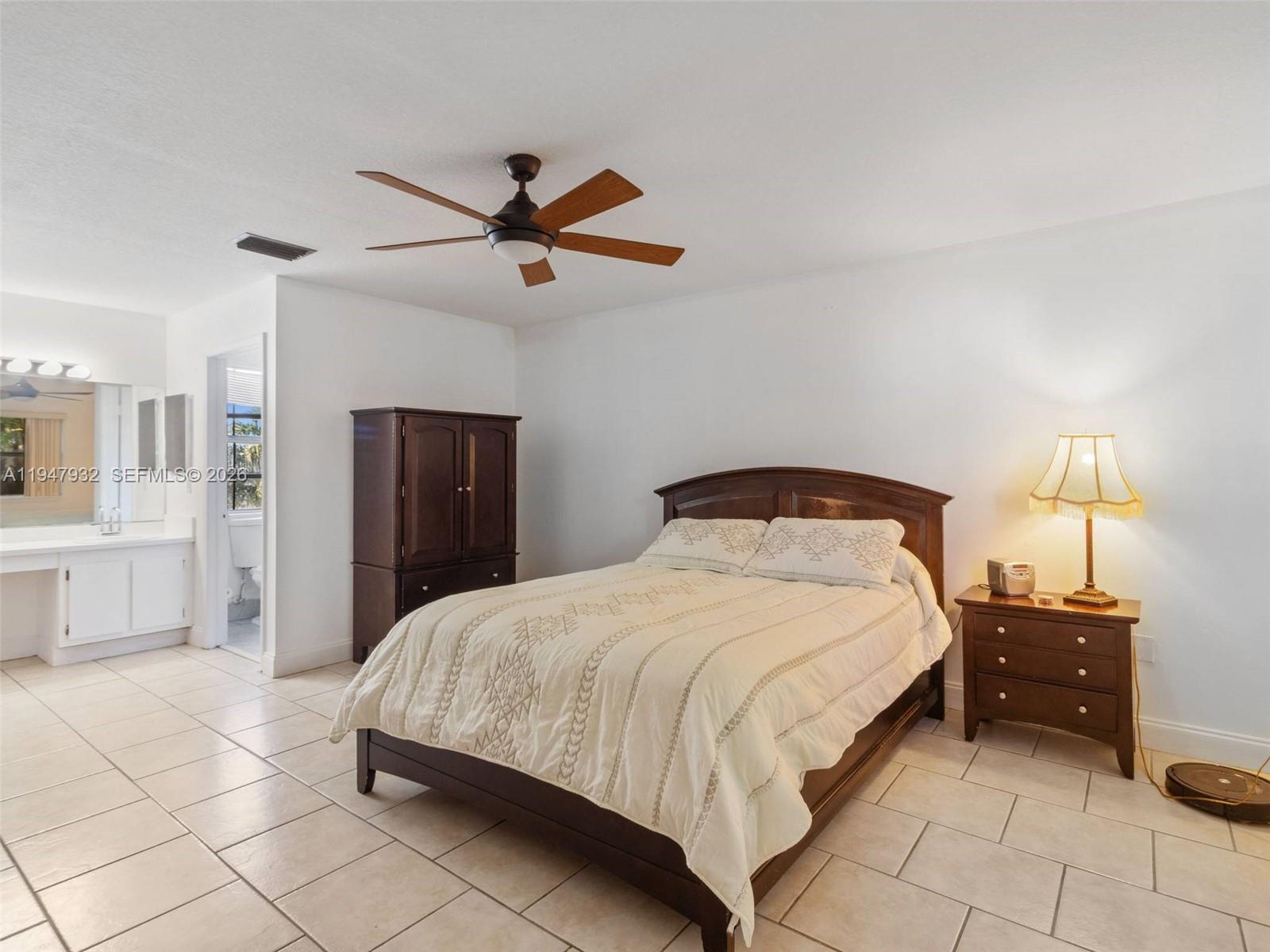 9066 Southwest 147th Court Miami, FL 33196 - Photo 14 of 31 a bedroom with a bed and a chandelier
