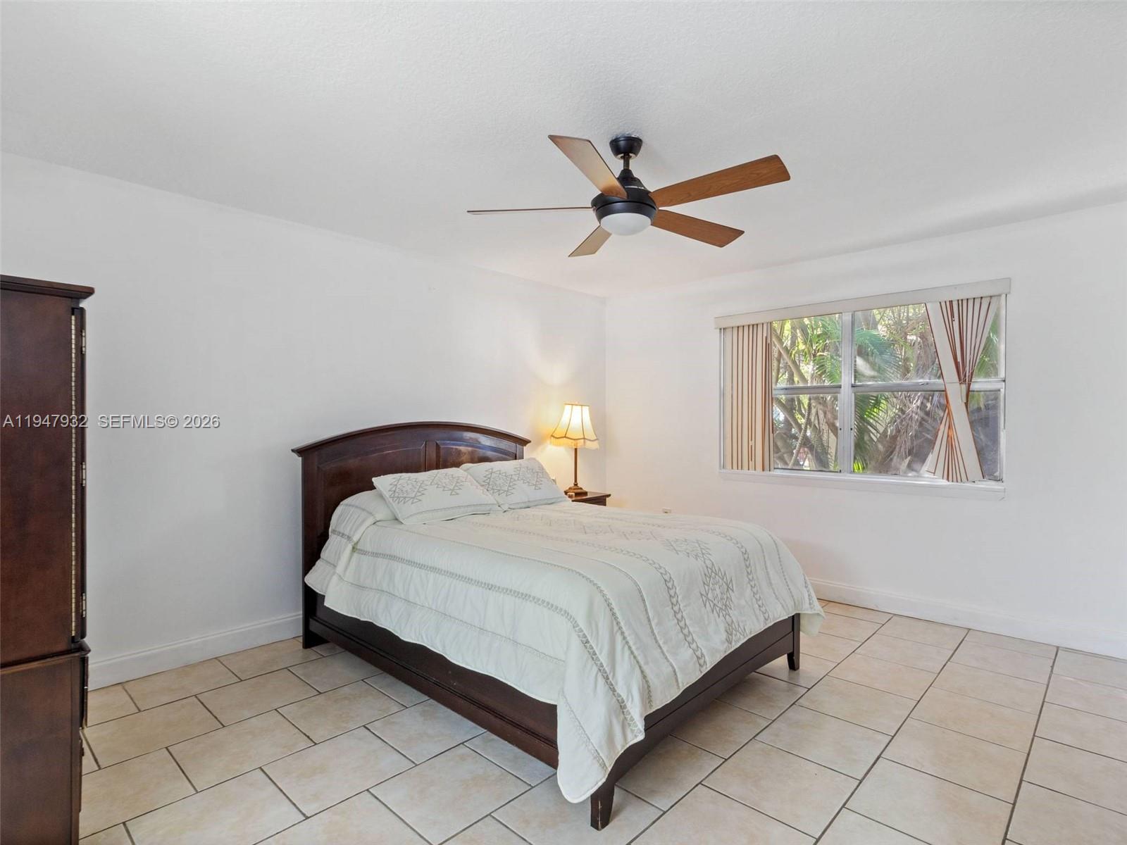 9066 Southwest 147th Court Miami, FL 33196 - Photo 15 of 31 a bedroom with a bed and a window