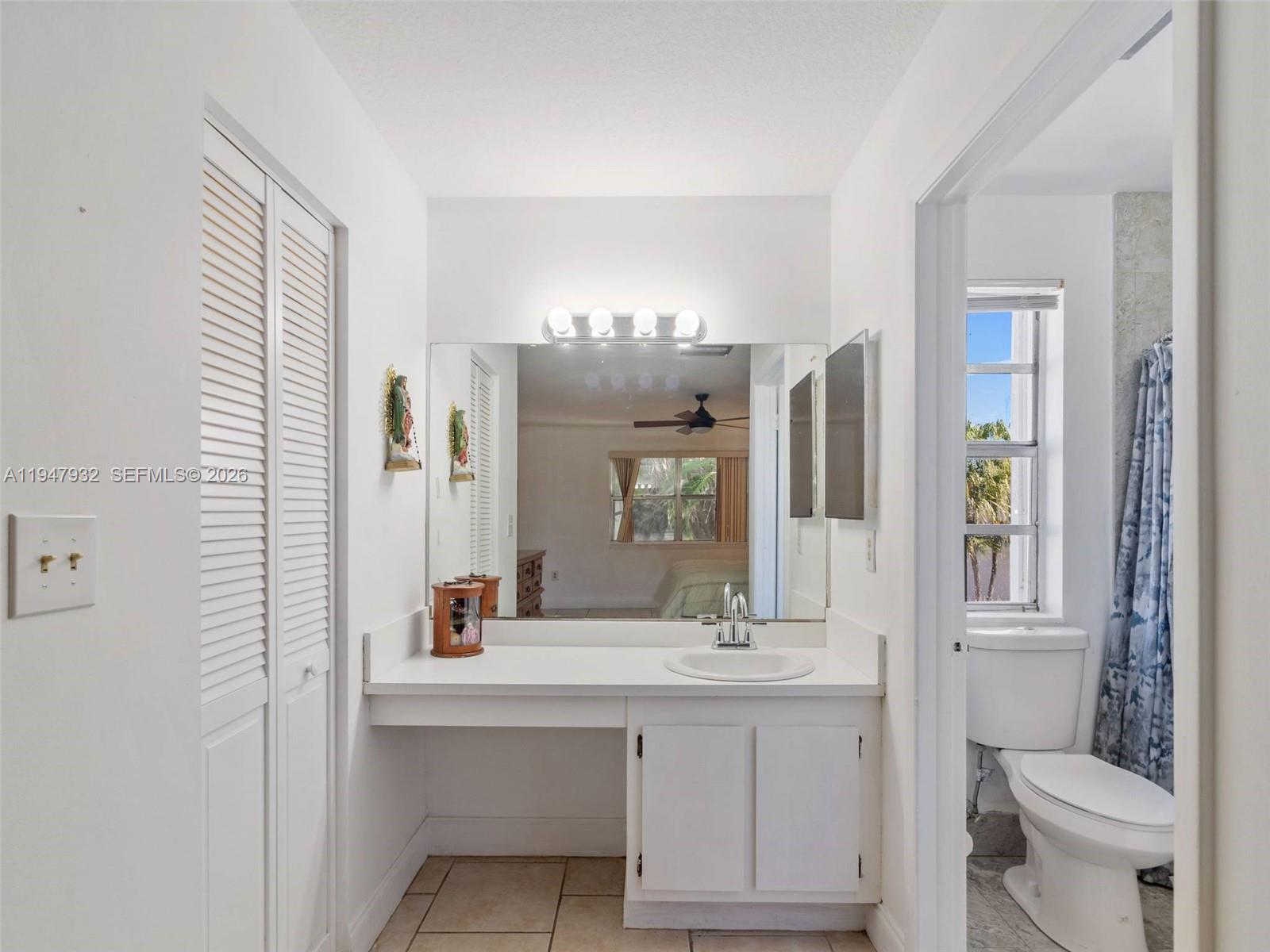 9066 Southwest 147th Court Miami, FL 33196 - Photo 16 of 31 a bathroom with a double vanity sink and a mirror