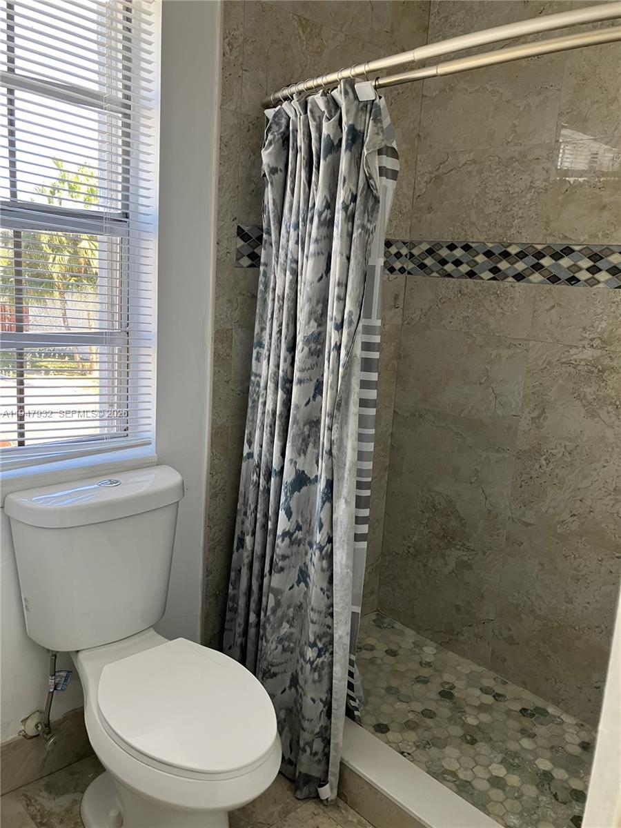 9066 Southwest 147th Court Miami, FL 33196 - Photo 17 of 31 a bathroom with a toilet and a shower