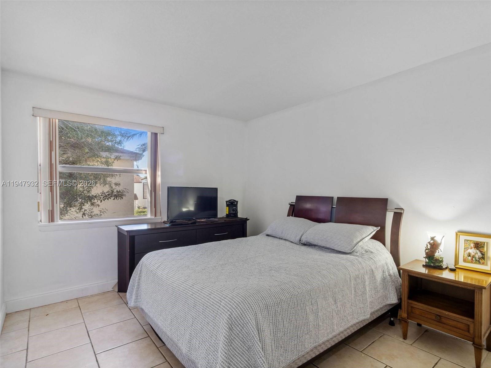 9066 Southwest 147th Court Miami, FL 33196 - Photo 19 of 31 a bedroom with a large bed and a window