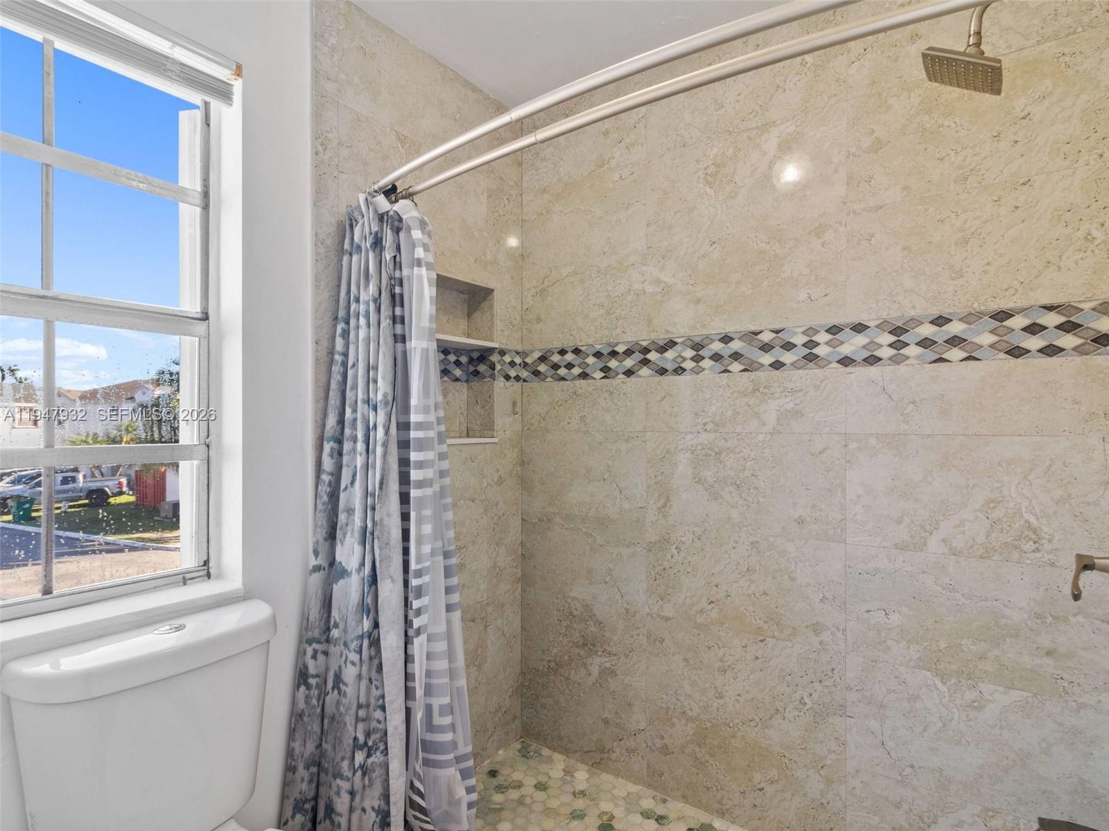 9066 Southwest 147th Court Miami, FL 33196 - Photo 23 of 31 a bathroom with a shower and a window