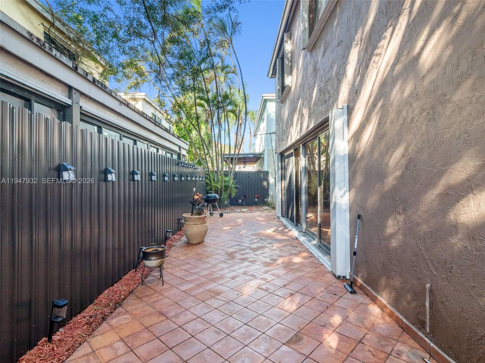 9066 Southwest 147th Court Miami, FL 33196 - Photo 24 of 31 a view of a pathway of a house with wooden fence