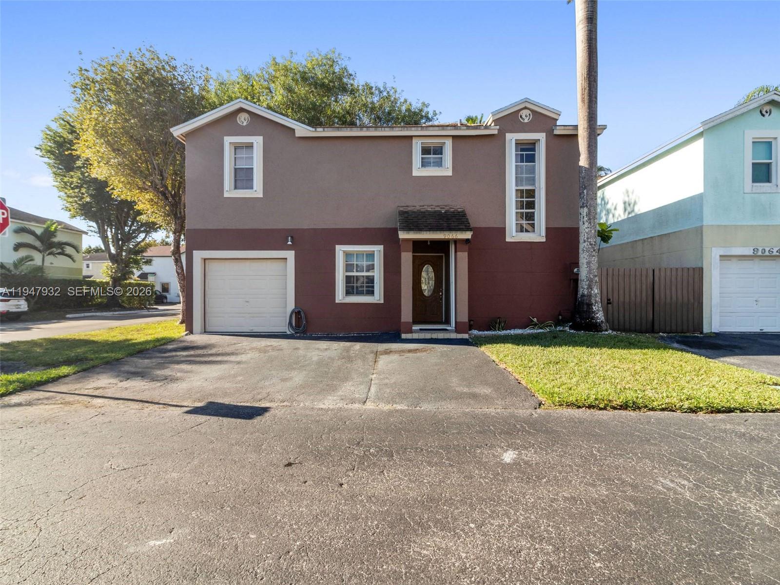 9066 Southwest 147th Court Miami, FL 33196 - Photo 31 of 31 a front view of a house with a yard and garage