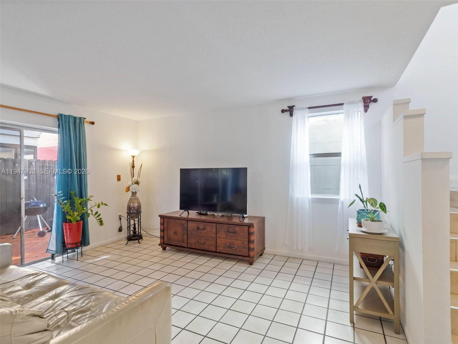 9066 Southwest 147th Court Miami, FL 33196 - Photo 6 of 31 a room with furniture and a flat screen tv
