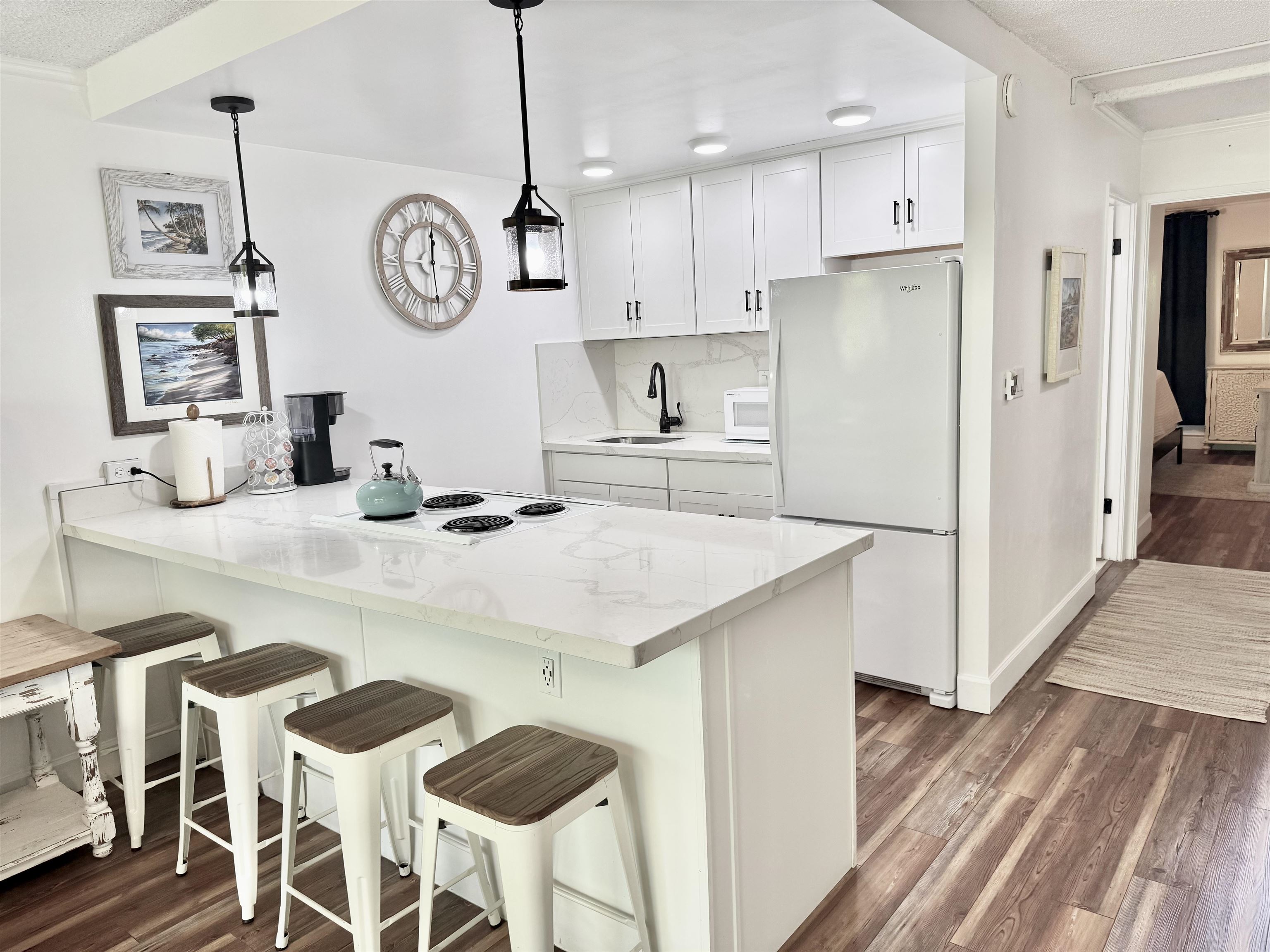 120 Hui Rd F, Unit B5 Lahaina, HI 96761 - Photo 2 of 17 a kitchen with a table chairs refrigerator and cabinets
